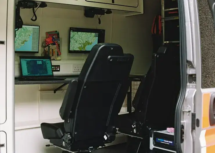 Dispatch workstation with multiple monitors inside a command vehicle