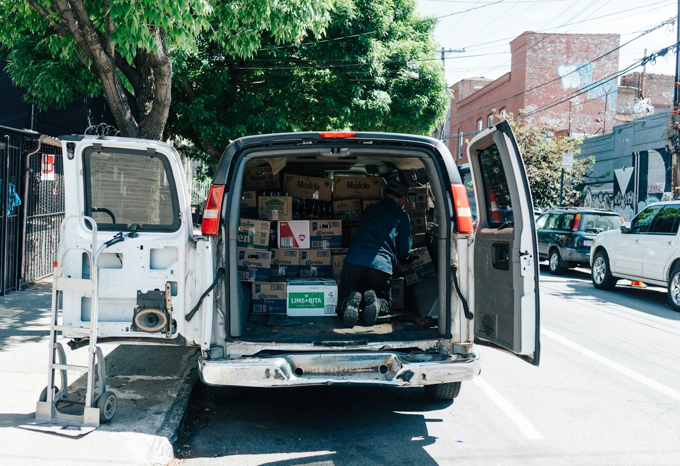 Open rear of a delivery van packed with parcels on a city street